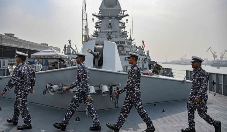 Sailors walk on the deck of the INS Imphal (Yard 12706)